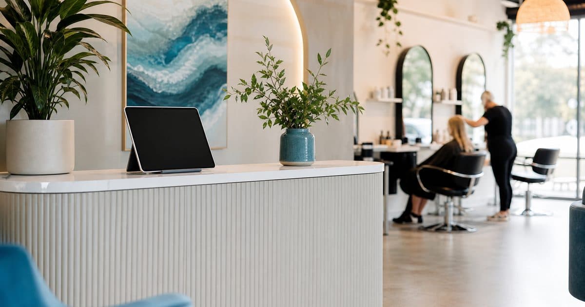 Modern salon reception desk with a tablet booking system