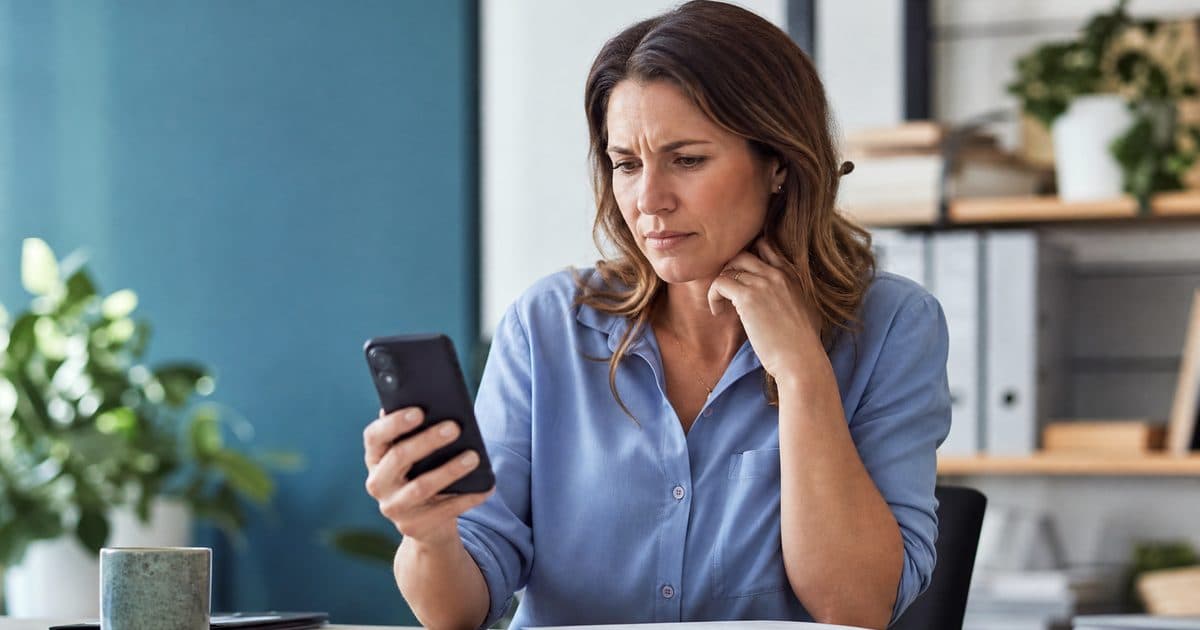 Small business owner noticing missed enquiries on a phone